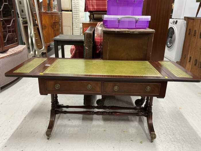 A mahogany drop leaf sofa coffee table, with a tooled and gilt green leather inlaid top, on...
