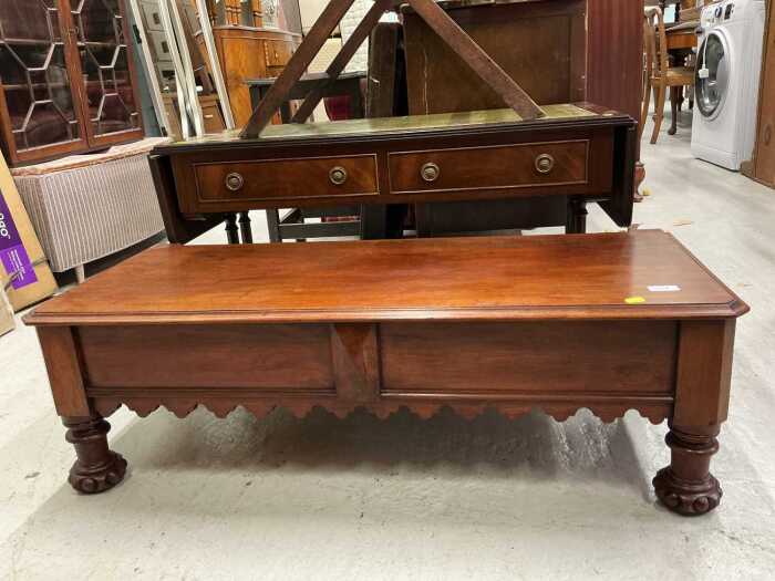 A mahogany low table, with carved feet.
