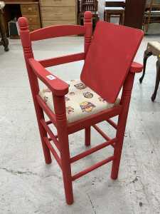 A child's painted highchair, with owl seat.
