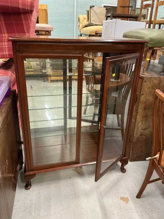 A mahogany finish display cabinet.