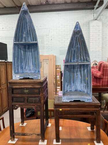 A pair of ship end display cabinets, each with an open shelf, partially painted in blue, an...