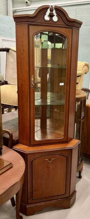 A freestanding corner cupboard.