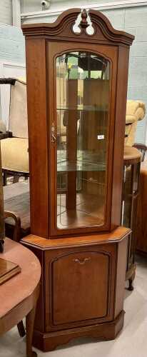 A freestanding corner cupboard.