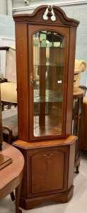 A freestanding corner cupboard.