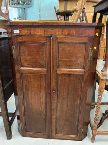 A 19thC mahogany hanging corner cupboard, with panelled door.