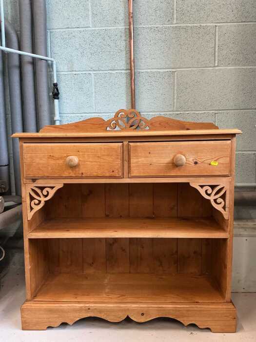 A pine cabinet, with two drawers above two shelves.