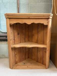 A pine hanging corner cupboard.