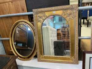 A pair of gilt wooden framed mirrors, one of decorated rectangular form enclosing an arch shaped...