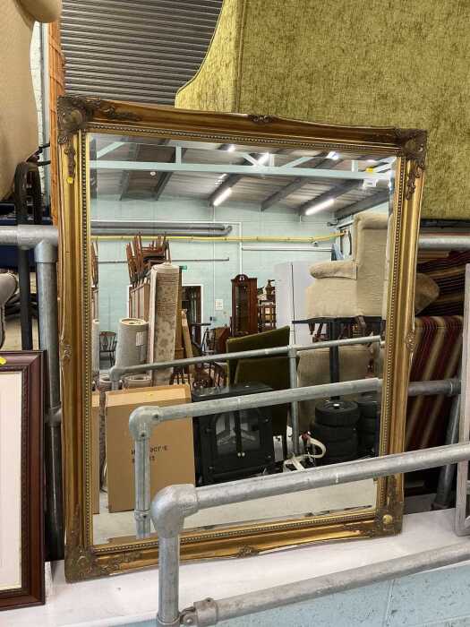 A large rectangular hanging mirror, with bevelled glass.