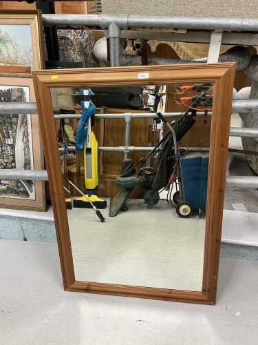 A pine framed mirror with bevelled glass.