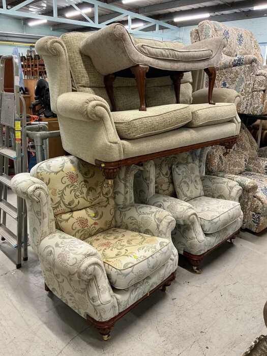 A matched lounge suite, comprising two seater settee and two armchairs, each in floral material,...