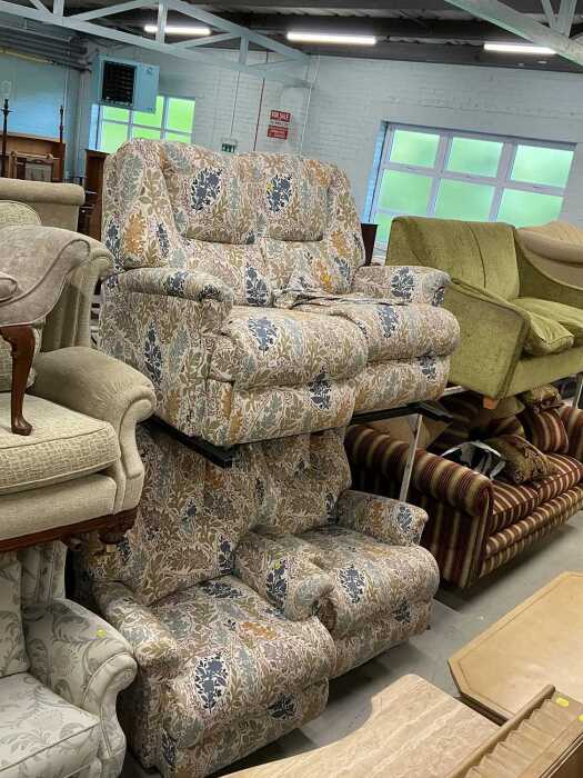A three piece lounge suite, comprising two seater settee and two armchairs, in floral material....