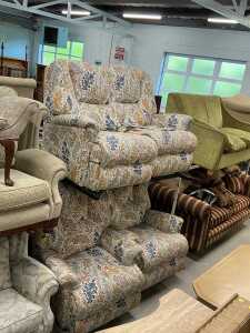 A three piece lounge suite, comprising two seater settee and two armchairs, in floral material....
