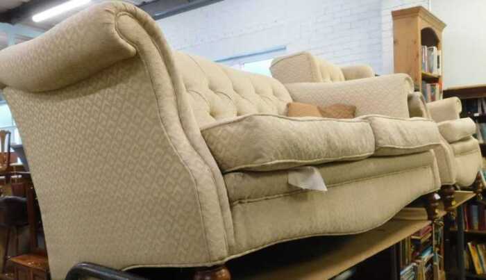 An Edwardian style two piece lounge suite, comprising two seater sofa, with serpentine back,...