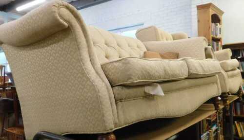 An Edwardian style two piece lounge suite, comprising two seater sofa, with serpentine back,...