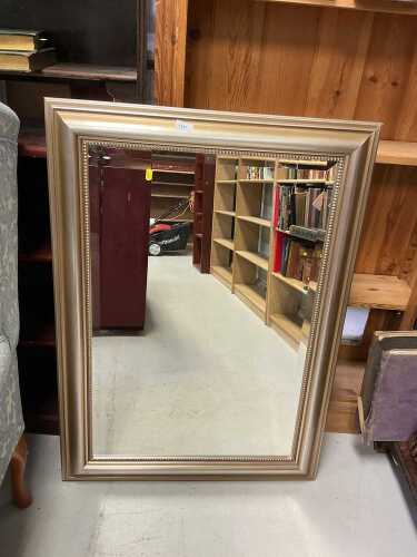 A rectangular hanging mirror, with bevelled glass.