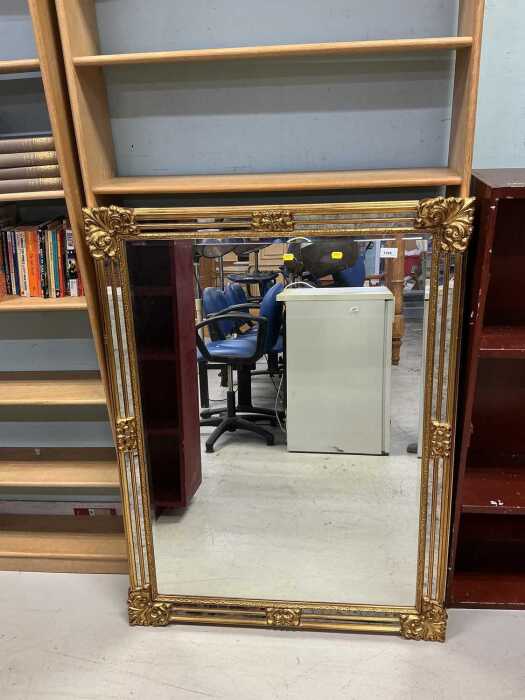A rectangular hanging mirror, with bevelled glass.