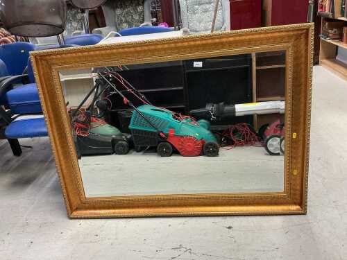 A rectangular hanging mirror, with bevelled glass.