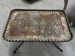 A highly decorative Eastern coffee table, with metal top, on an entwined iron stand.
