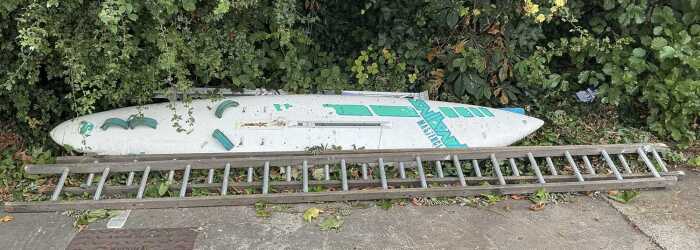 A Masterclass Brian Hide with J Frahne Artwork windsurfing board, and various step ladders.