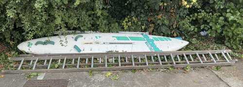 A Masterclass Brian Hide with J Frahne Artwork windsurfing board, and various step ladders.