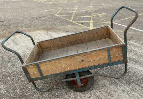 A 20thC slatted two wheeled trailer, with iron frame and handle to each side, partially painted...
