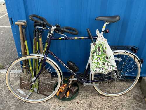 A Sterling Tour bicycle and various hand tools.