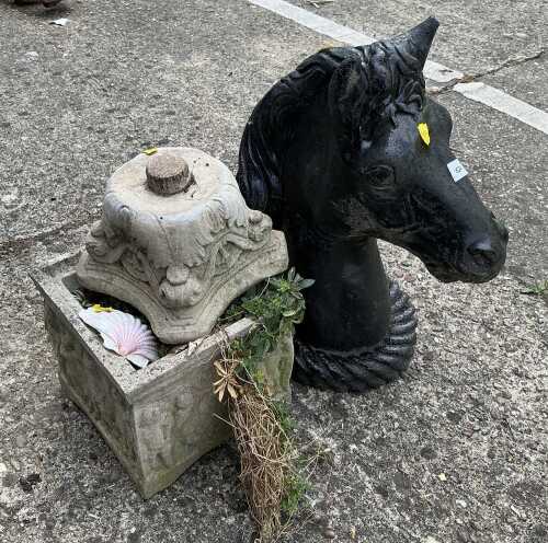 A horse head plinth, and a small planter.