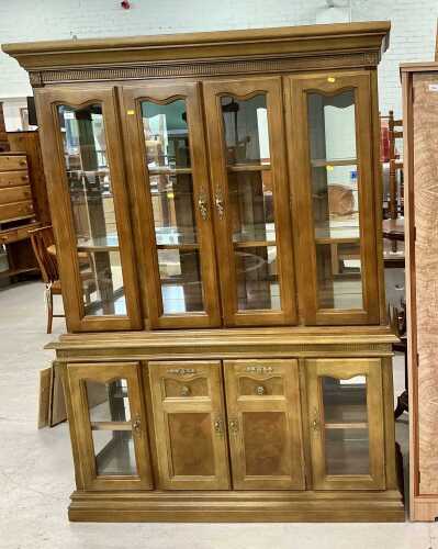 A four door glazed bookcase, with fixed cornice, raised above adjustable shelves and four...