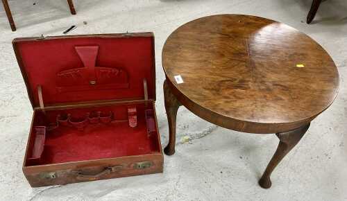 A mid 20thC walnut quarter veneered coffee table, of circular form, on cylindrical legs...