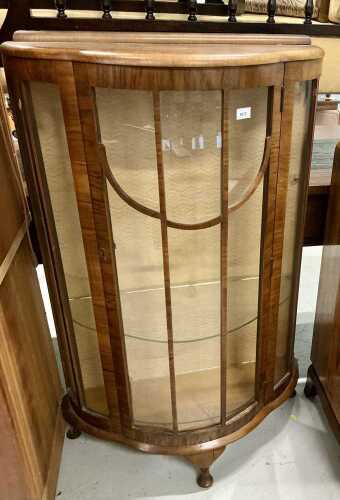 A 1950s walnut bow fronted cabinet.