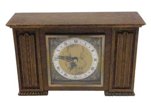 A 20thC oak cased mantel clock, the 9cm diameter chapter ring with Roman numerals, with a gilt...