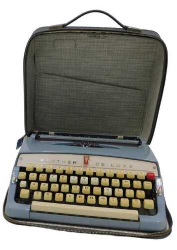 A vintage Brother De-luxe typewriter, in cream and blue colourway, 29cm wide, in fitted case.