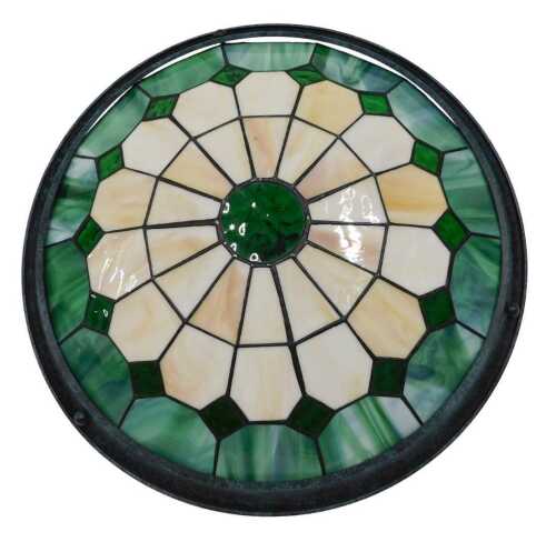 A Tiffany style light shade, of circular form, in a geometric pattern predominantly in green and...
