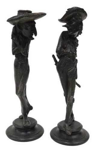 A pair of French spelter candlestick caricature figures, of Cyrano and Harpagon, each on an...