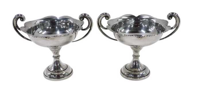 A pair of late Edward VII silver bonbon dishes, each with scroll handles, flared floral rims,...