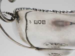A pair of late Edward VII silver bonbon dishes, each with scroll handles, flared floral rims,... - 4