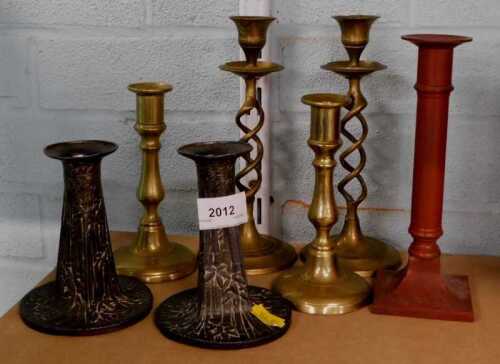 Various candlesticks, brass and others, textured and plated examples, metal red candlestick of...