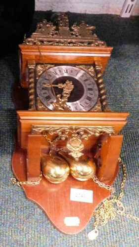 A Dutch Zaanse Zaandam weight driven wall clock, with Roman numeric dial and two weights.