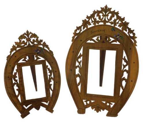 Two highly elaborate carved wooden frames, with pierced scroll finials and fretwork horseshoe...