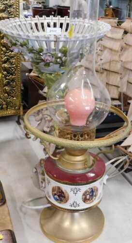 A 20thC Sitzendorf style porcelain centrepiece, with cherub stem, profusely decorated with...