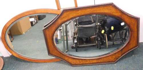 An oak framed oval mirror, with bevelled glass, and a further 1930s oak mirror with beaded outline.