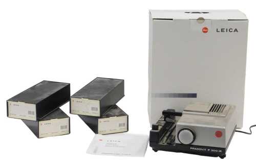 A Leica Pradovit P300IR 35mm slide projector, with some ephemera and various vacant Leica slide...