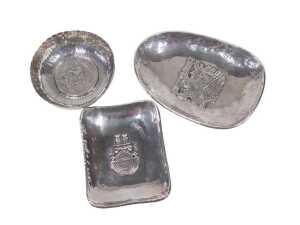 An early 20thC Peruvian dish, of egg shaped form, with hammered border and raised central...