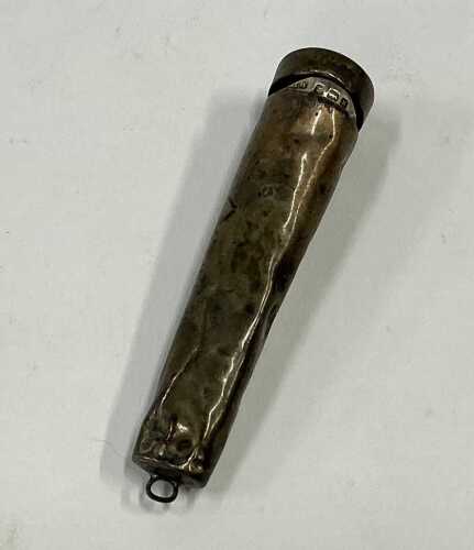 A silver cigarette or match holder.