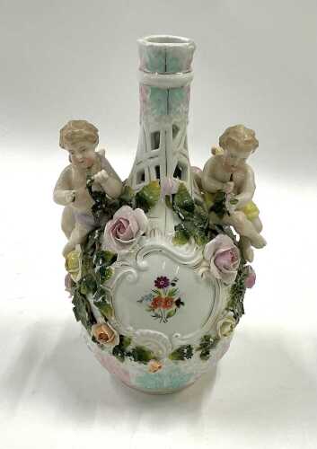 A Continental Sitzendorf porcelain vase, with cherubic handles, double cross mark beneath.
