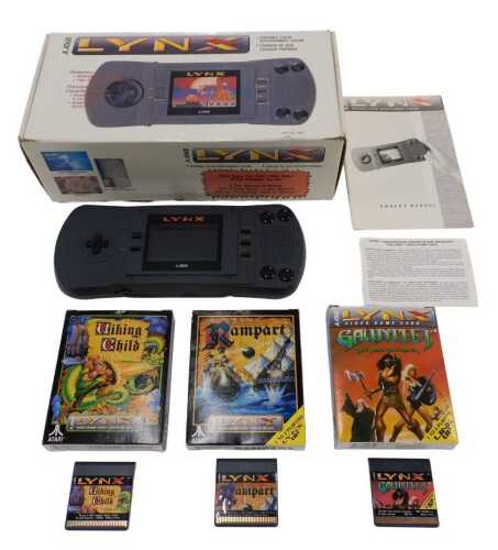 An Atari Lynx portable colour entertainment handheld game system, 28cm wide, with power cable,...