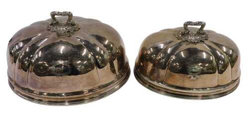 A graduated pair of early 20thC silver plated meat covers, of domed form, with elaborate scroll...