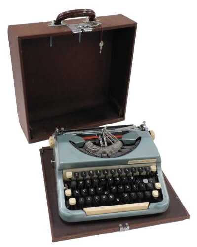 A vintage Imperial Good Companion typewriter, in blue and white trim, with articulated black and...