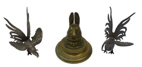 An early 20thC brass novelty inkwell, formed as a hare's head, hinging to reveal a ceramic ink...